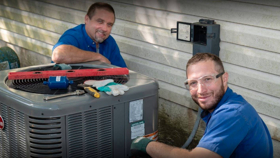 Two HVAC professionals outside a home in Cibolo, TX, with tools, are repairing an air conditioning system. 